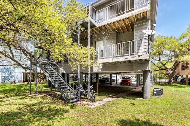 5306 Indio Cv, Austin, TX 78745 - rear view of house featuring a yard, stairway, a balcony, and central air condition unit