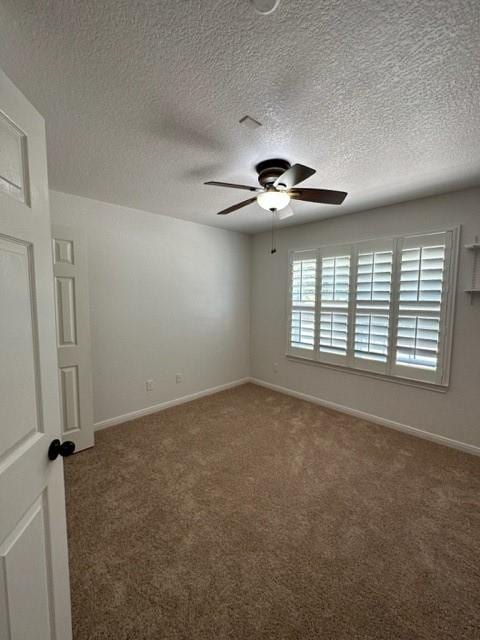 11708 Bittern Holw, Austin, TX 78758 - unfurnished room with ceiling fan, carpet floors, a textured ceiling, and baseboards