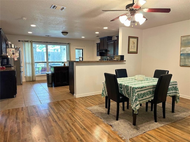 11708 Bittern Holw, Austin, TX 78758 - dining area with light wood-type flooring, a ceiling fan, a textured ceiling, recessed lighting, and baseboards
