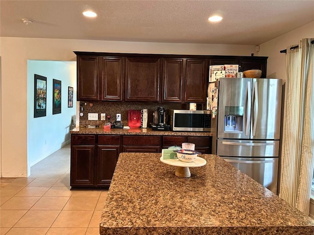 11708 Bittern Holw, Austin, TX 78758 - kitchen with appliances with stainless steel finishes, dark brown cabinets, backsplash, light tile patterned flooring, and recessed lighting