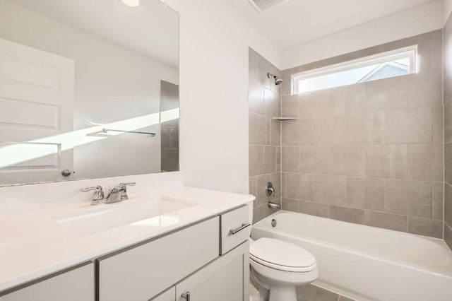 bathroom featuring shower / washtub combination, visible vents, toilet, and vanity