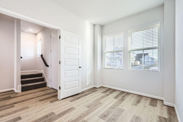 unfurnished bedroom with baseboards and light wood-style floors