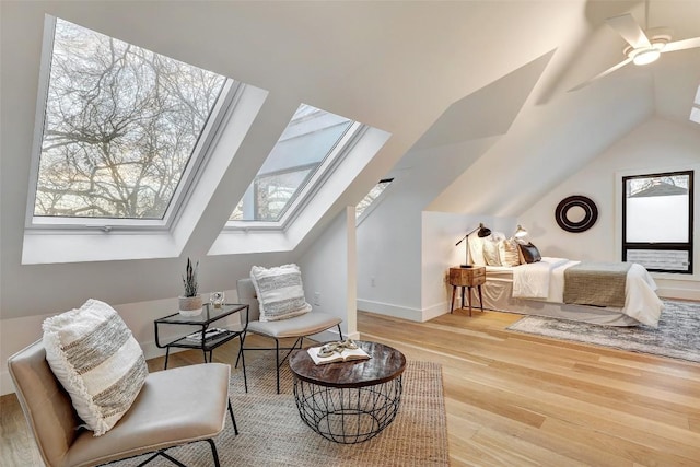 2009 Riverview St, Austin, TX 78702 - living area featuring a skylight, plenty of natural light, lofted ceiling, and wood finished floors