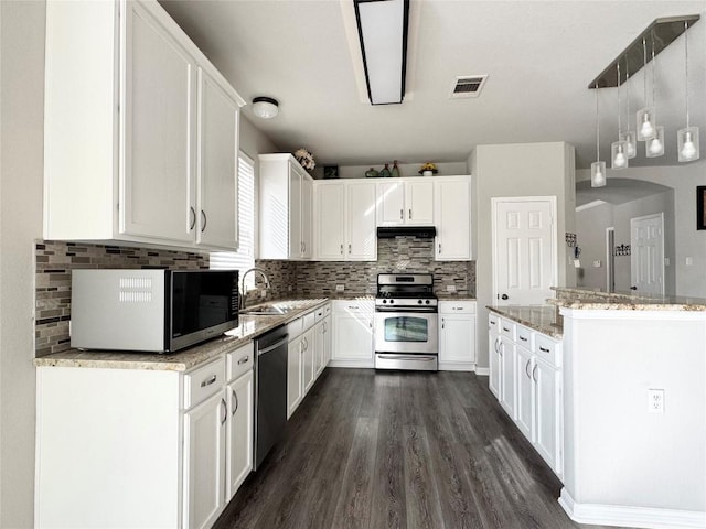 13004 Kenswick Dr, Austin, TX 78753 - kitchen with stainless steel appliances, light stone counters, white cabinets, dark wood-style flooring, and a sink