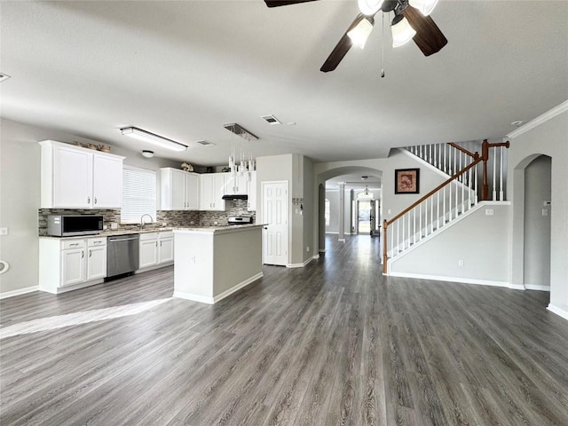 13004 Kenswick Dr, Austin, TX 78753 - kitchen with arched walkways, appliances with stainless steel finishes, open floor plan, and wood finished floors