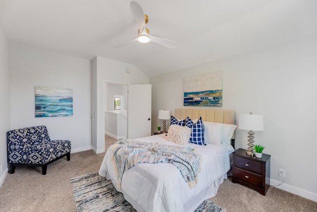 carpeted bedroom with baseboards, vaulted ceiling, and ceiling fan