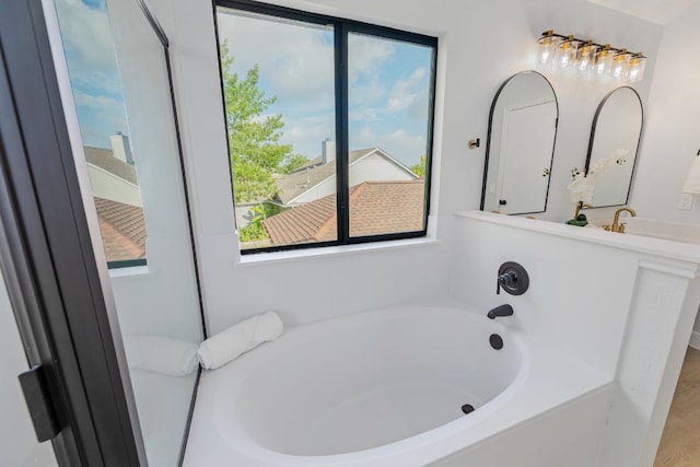 bathroom featuring a sink and a bath