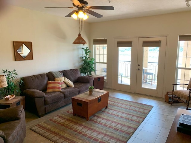 living area with french doors, a ceiling fan, and light tile patterned flooring