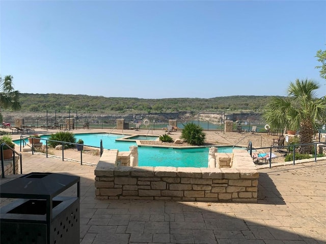 3404 American Dr Unit 2202, Lago Vista, TX 78645 - view of swimming pool featuring a forest view, a pool with connected hot tub, and a patio