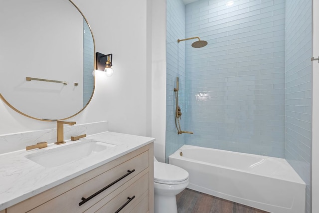 2450 Wickersham Ln Unit 2013, Austin, TX 78741 - bathroom with toilet, wood finished floors, shower / washtub combination, and vanity