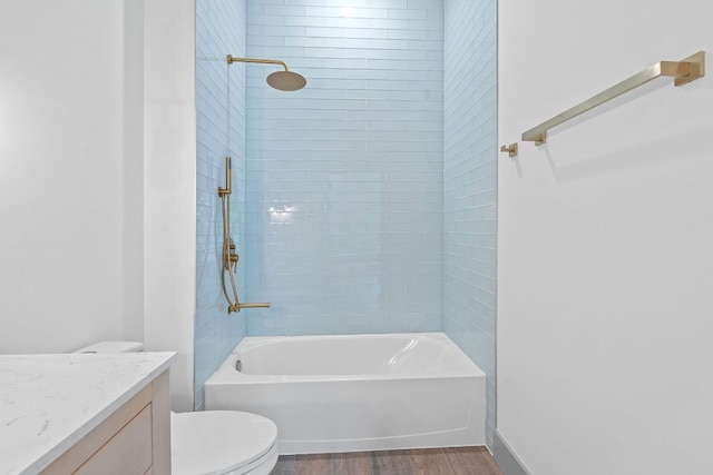 2450 Wickersham Ln Unit 2013, Austin, TX 78741 - full bath featuring toilet, wood finished floors, vanity, and  shower combination