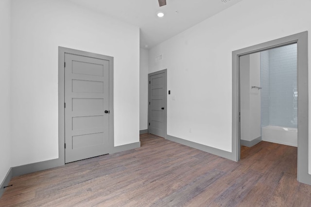 2450 Wickersham Ln Unit 2013, Austin, TX 78741 - unfurnished bedroom with wood finished floors, baseboards, and recessed lighting