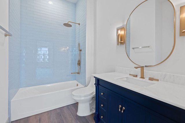 2450 Wickersham Ln Unit 2013, Austin, TX 78741 - full bathroom featuring wood finished floors, toilet, vanity, and  shower combination