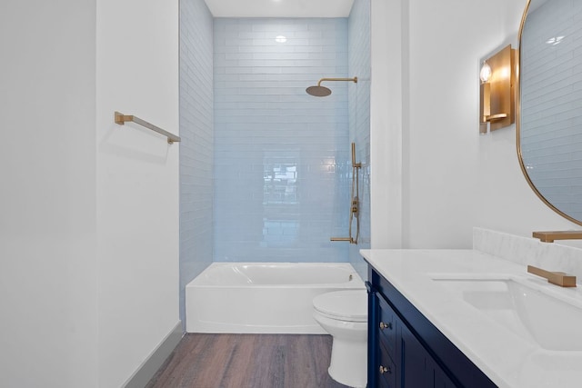 2450 Wickersham Ln Unit 2013, Austin, TX 78741 - bathroom with wood finished floors, toilet, vanity, and shower / bathtub combination