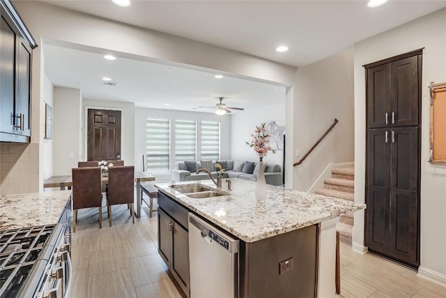 13800 Lyndhurst St Unit 325, Austin, TX 78717 - kitchen with stainless steel appliances, a sink, light stone counters, tasteful backsplash, and recessed lighting