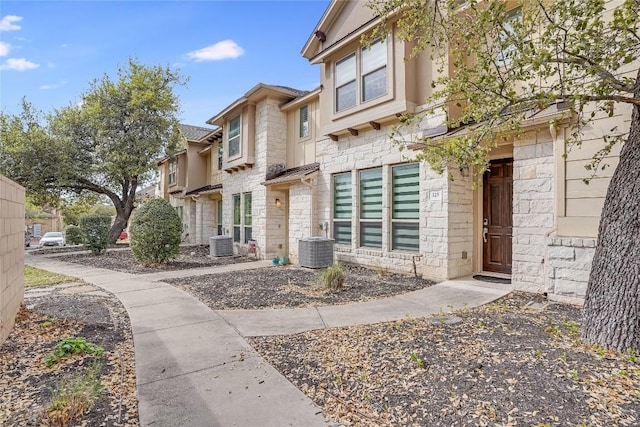 13800 Lyndhurst St Unit 325, Austin, TX 78717 - view of front of home with stone siding and central AC