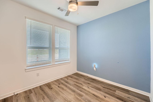 3213 Zach Scott St, Austin, TX 78723 - unfurnished room featuring ceiling fan, wood finished floors, and baseboards