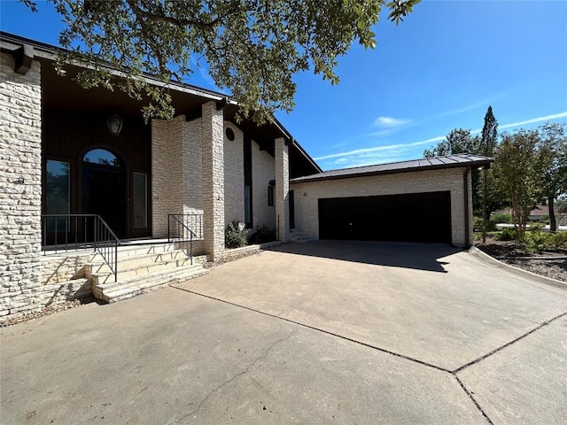 712 Rolling Green Dr, Lakeway, TX 78734 - exterior space with an attached garage, brick siding, and concrete driveway