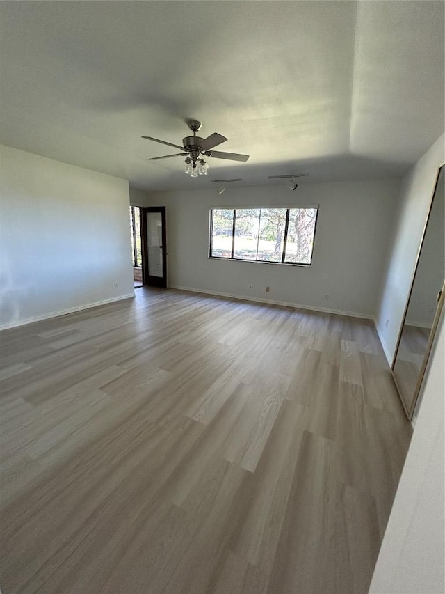 712 Rolling Green Dr, Lakeway, TX 78734 - spare room featuring a ceiling fan, light wood-style flooring, and baseboards