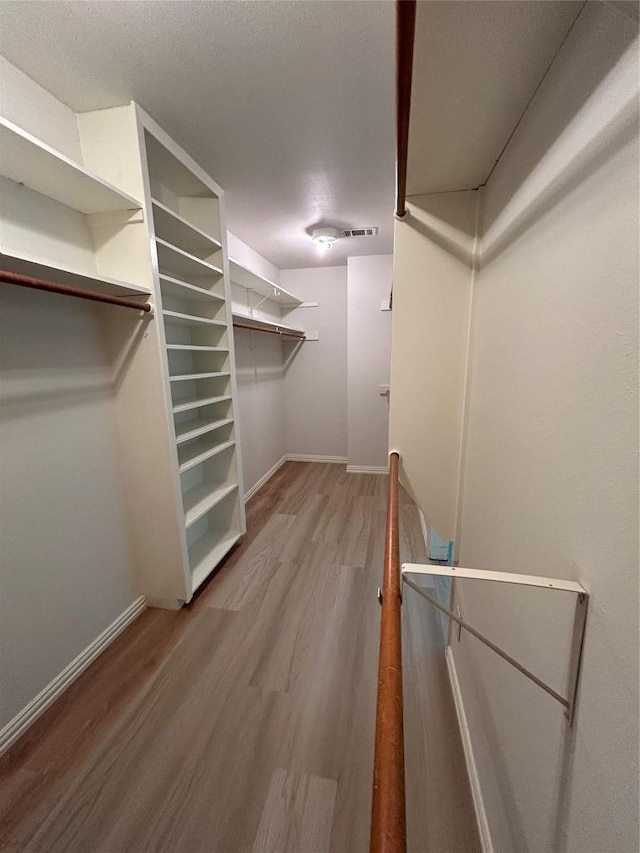 712 Rolling Green Dr, Lakeway, TX 78734 - spacious closet featuring visible vents and wood finished floors