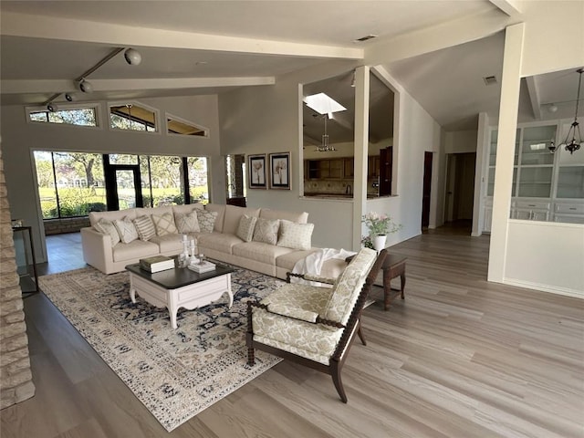 712 Rolling Green Dr, Lakeway, TX 78734 - living area featuring beamed ceiling, wood finished floors, and high vaulted ceiling