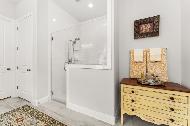 bathroom with baseboards, visible vents, a shower stall, and recessed lighting