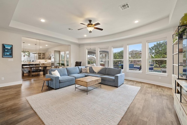 1924 Portobello Rd, Leander, TX 78641 - living area with a raised ceiling, a ceiling fan, recessed lighting, and wood finished floors