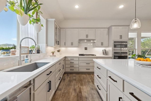 1924 Portobello Rd, Leander, TX 78641 - kitchen with decorative backsplash, dark wood-type flooring, light countertops, decorative light fixtures, and recessed lighting