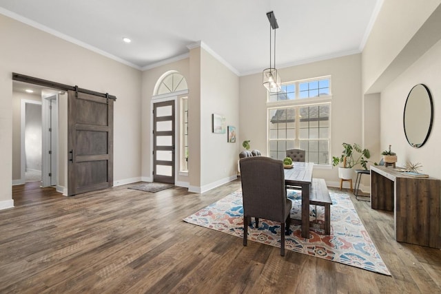 1924 Portobello Rd, Leander, TX 78641 - dining area featuring a barn door, wood finished floors, ornamental molding, recessed lighting, and a towering ceiling