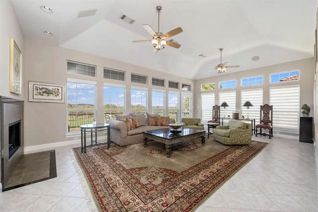 6 Radnor Dr, Austin, TX 78738 - living room with light tile patterned flooring, ceiling fan, a glass covered fireplace, baseboards, and vaulted ceiling