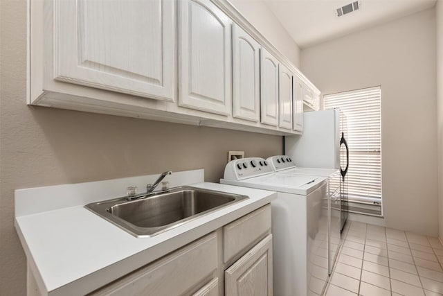 6 Radnor Dr, Austin, TX 78738 - laundry room with washer and dryer, cabinet space, and light tile patterned floors