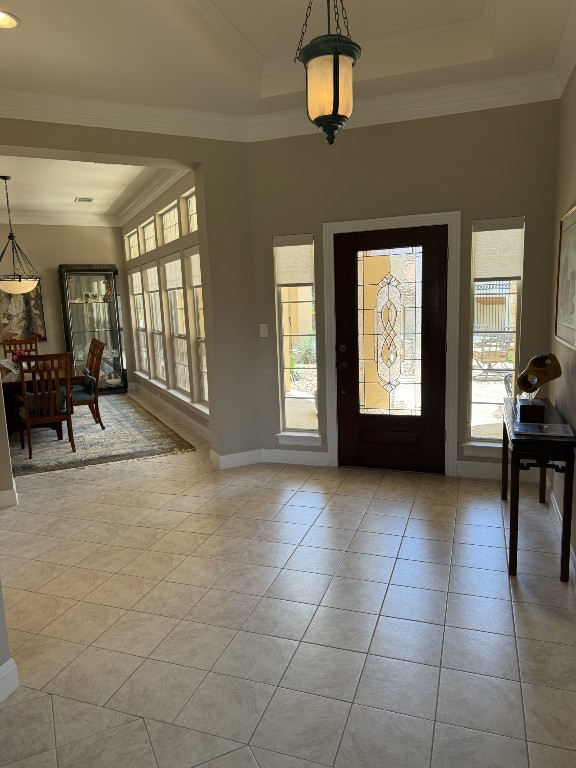 6 Radnor Dr, Austin, TX 78738 - foyer featuring light tile patterned floors, baseboards, ornamental molding, and a tray ceiling