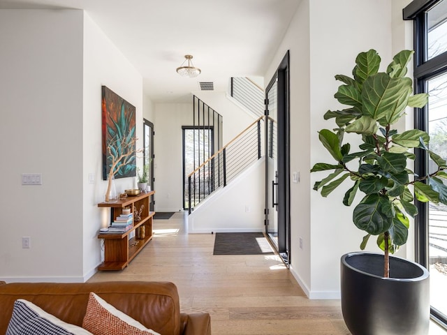 1510 Bellaire Dr, Austin, TX 78741 - foyer entrance with light wood-style floors and stairway