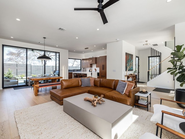 1510 Bellaire Dr, Austin, TX 78741 - living area featuring a ceiling fan, recessed lighting, light wood-type flooring, and stairway
