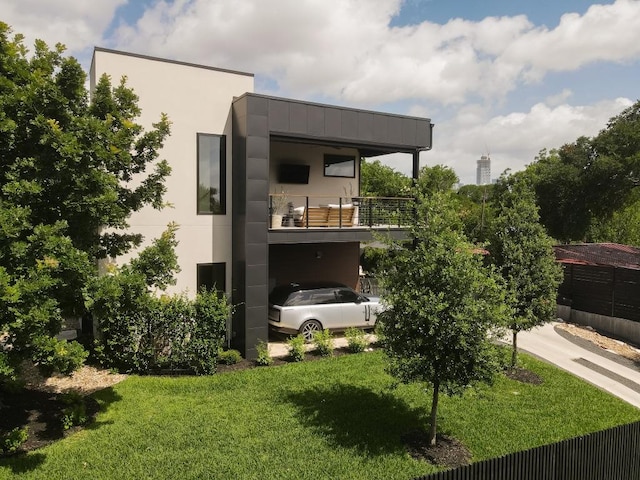 1510 Bellaire Dr, Austin, TX 78741 - view of home's exterior featuring a balcony, a lawn, and stucco siding