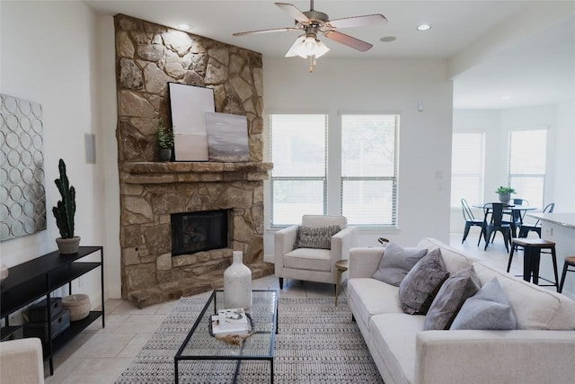 living room featuring ceiling fan, recessed lighting, light tile patterned floors, and a stone fireplace