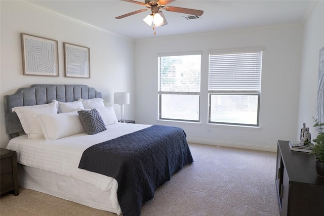 carpeted bedroom with baseboards, visible vents, ornamental molding, and a ceiling fan