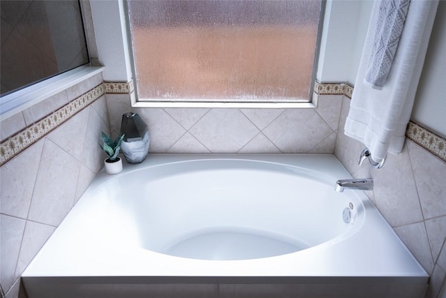 full bath with tile walls and a garden tub