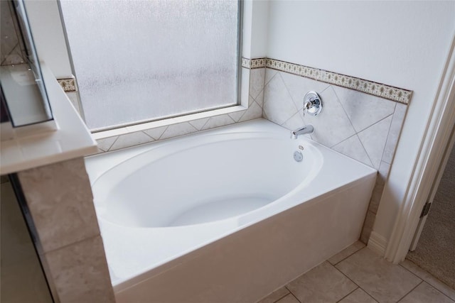 bathroom with tile patterned floors and a garden tub