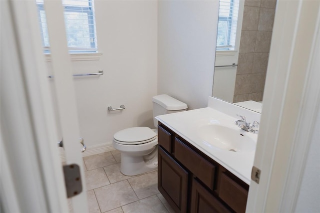 bathroom featuring tile patterned floors, vanity, plenty of natural light, and toilet