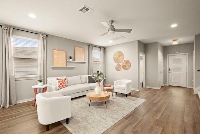 7800 Linnie Ln, Austin, TX 78724 - living room featuring a ceiling fan, recessed lighting, wood finished floors, and plenty of natural light