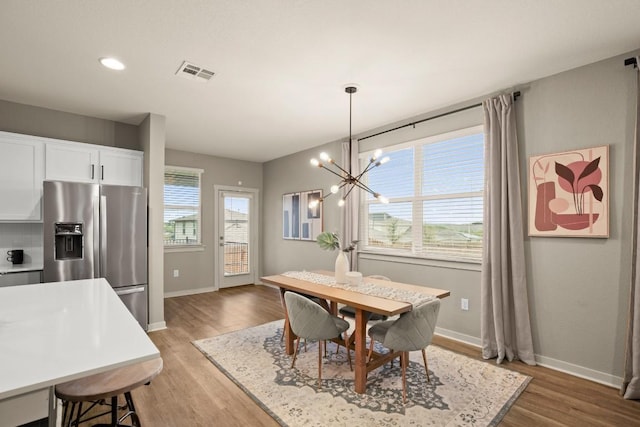 7800 Linnie Ln, Austin, TX 78724 - dining area with light wood-style floors and a chandelier