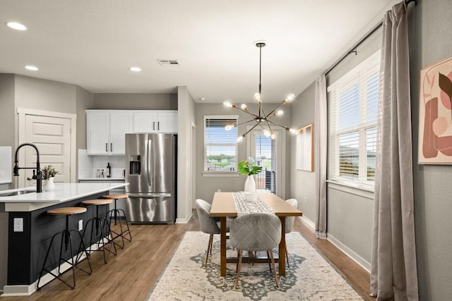 7800 Linnie Ln, Austin, TX 78724 - dining space featuring light wood-style floors, a chandelier, and recessed lighting