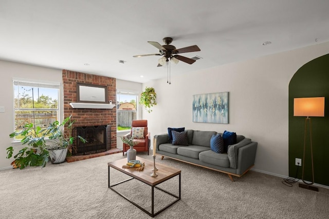 1302 Rambling Trl, Cedar Park, TX 78613 - carpeted living area with plenty of natural light, ceiling fan, a fireplace, and arched walkways