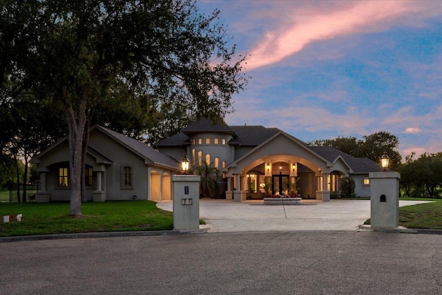 1317 Jack Nicklaus Cir, Salado, TX 76571 - french provincial home with a front yard, curved driveway, stucco siding, and an attached garage