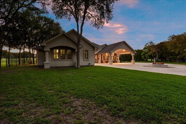 1317 Jack Nicklaus Cir, Salado, TX 76571 - back of property at dusk featuring a lawn