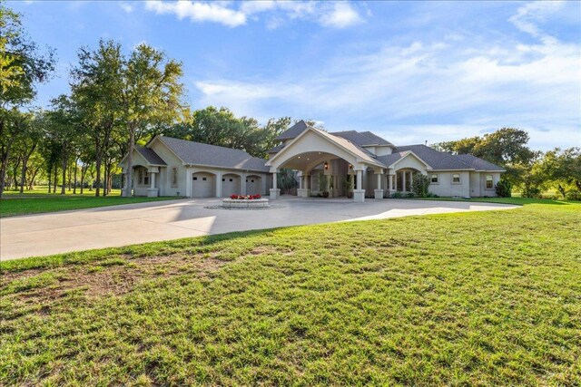 1317 Jack Nicklaus Cir, Salado, TX 76571 - view of front facade with driveway, a garage, a front lawn, and stucco siding