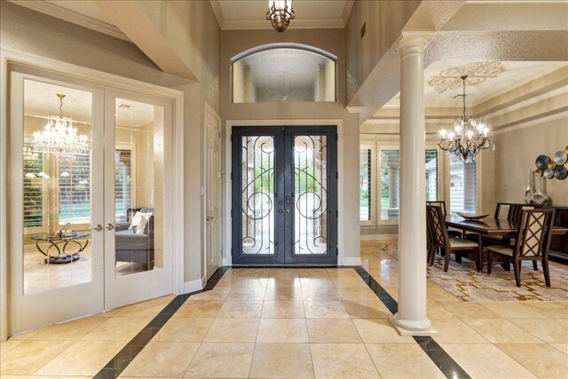 1317 Jack Nicklaus Cir, Salado, TX 76571 - foyer featuring baseboards, ornamental molding, french doors, and a notable chandelier