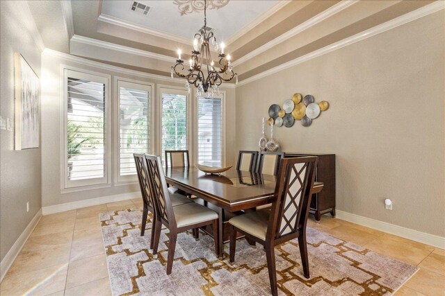 1317 Jack Nicklaus Cir, Salado, TX 76571 - dining room featuring light tile patterned flooring, crown molding, baseboards, a raised ceiling, and a notable chandelier