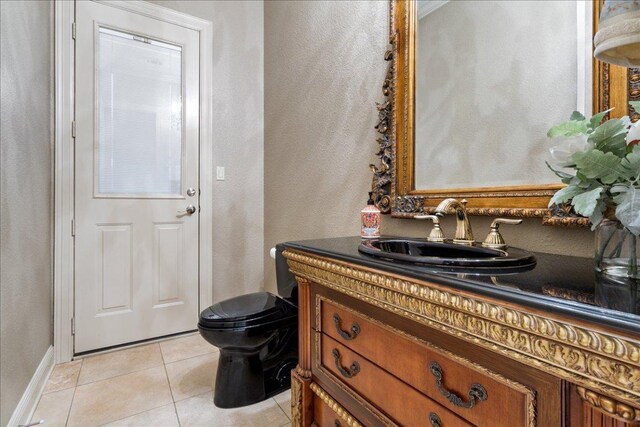 1317 Jack Nicklaus Cir, Salado, TX 76571 - half bathroom with tile patterned floors, toilet, baseboards, and vanity